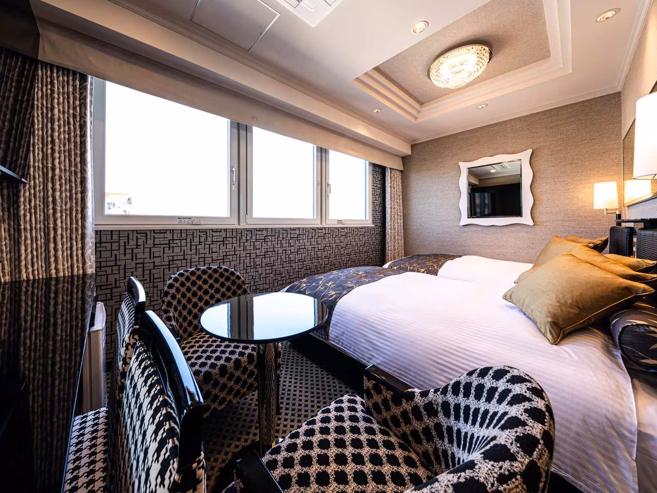 APA Deluxe Twin 21 m² room with two beds and lounge corner