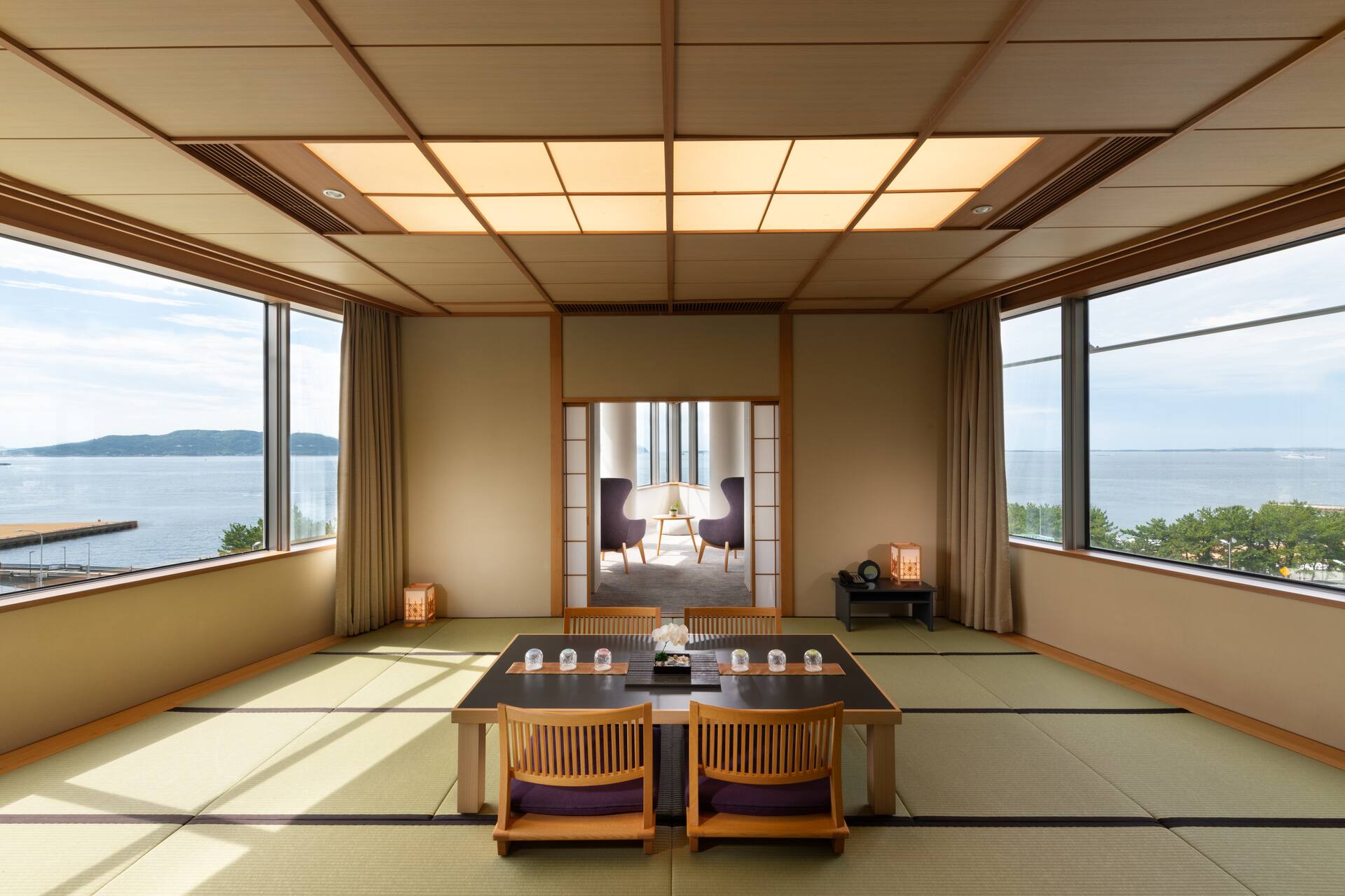 Japanese-style room with tatami area, low table, and floor cushions