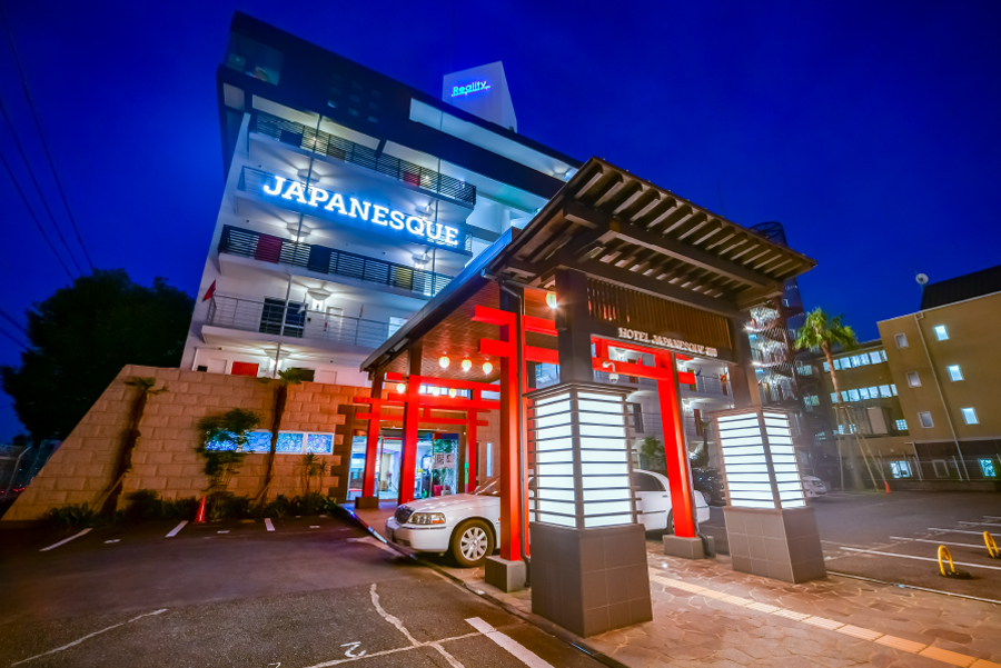 Hotel Japanesque Fukuoka entrance with torii-style gate and illuminated facade at night
