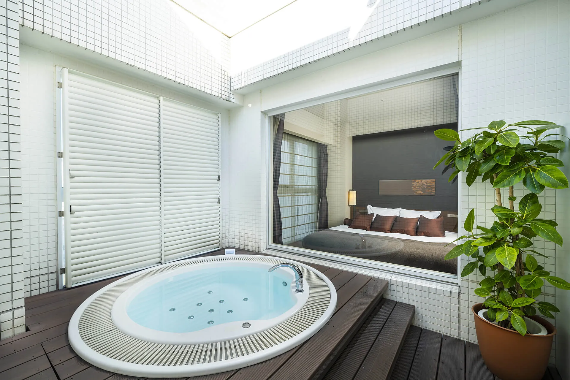 King Terrace room with outdoor jacuzzi on 14th floor at KOKO HOTEL Fukuoka Tenjin — open-air deck with round soaking tub