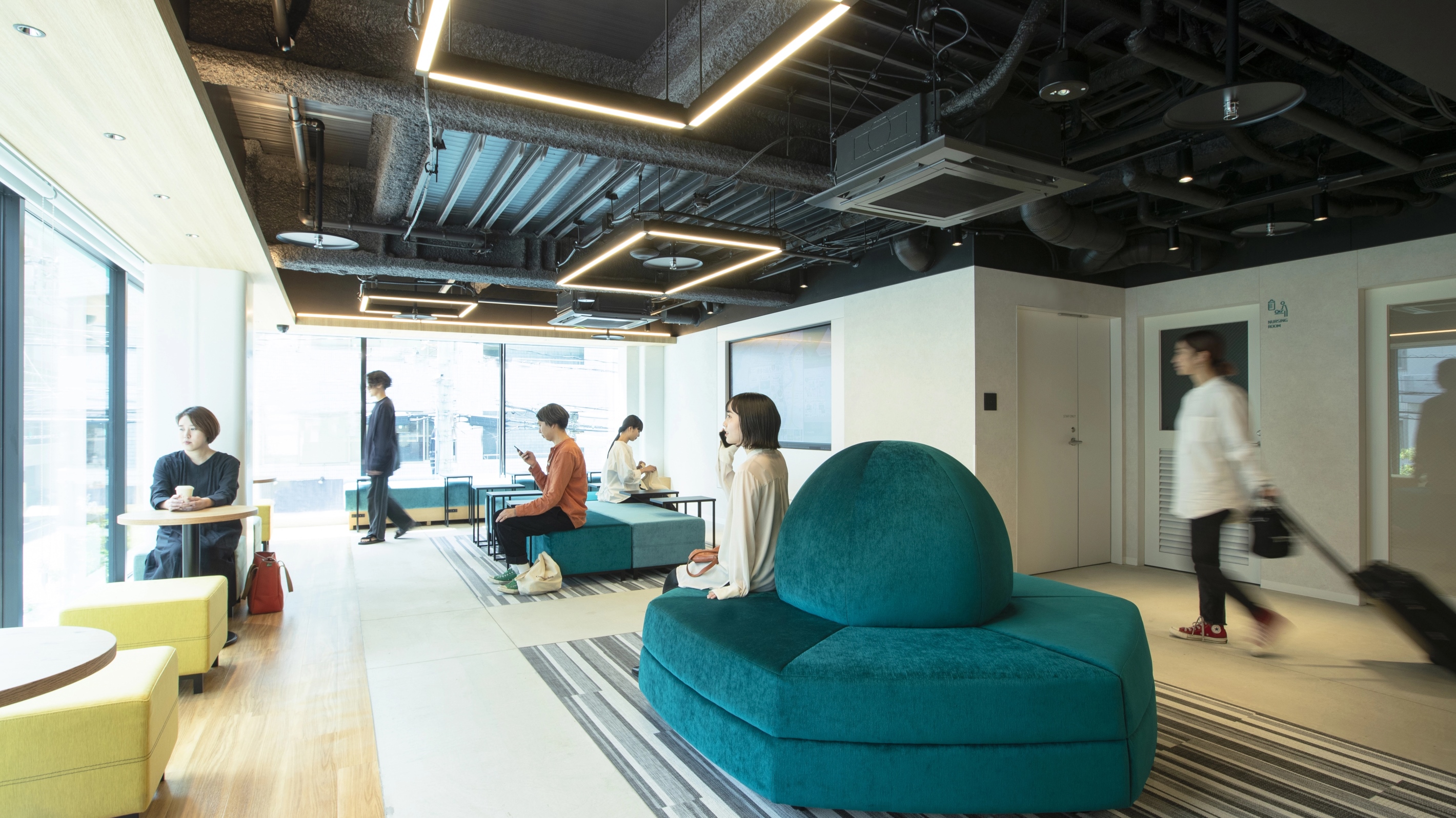Prince Smart Inn Hakata lobby common area with self check-in kiosks and green pod seating