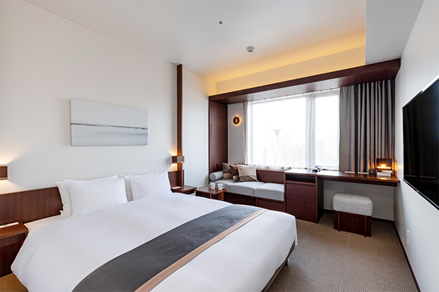 Standard room with twin beds and warm lighting at Tokyu Stay Fukuoka Tenjin