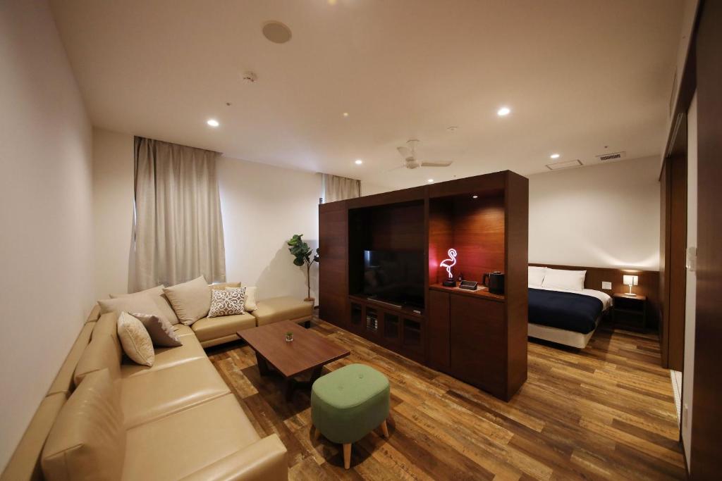 ZONK Hotel Hakata suite room (46 m²) with two double beds and a corner sofa